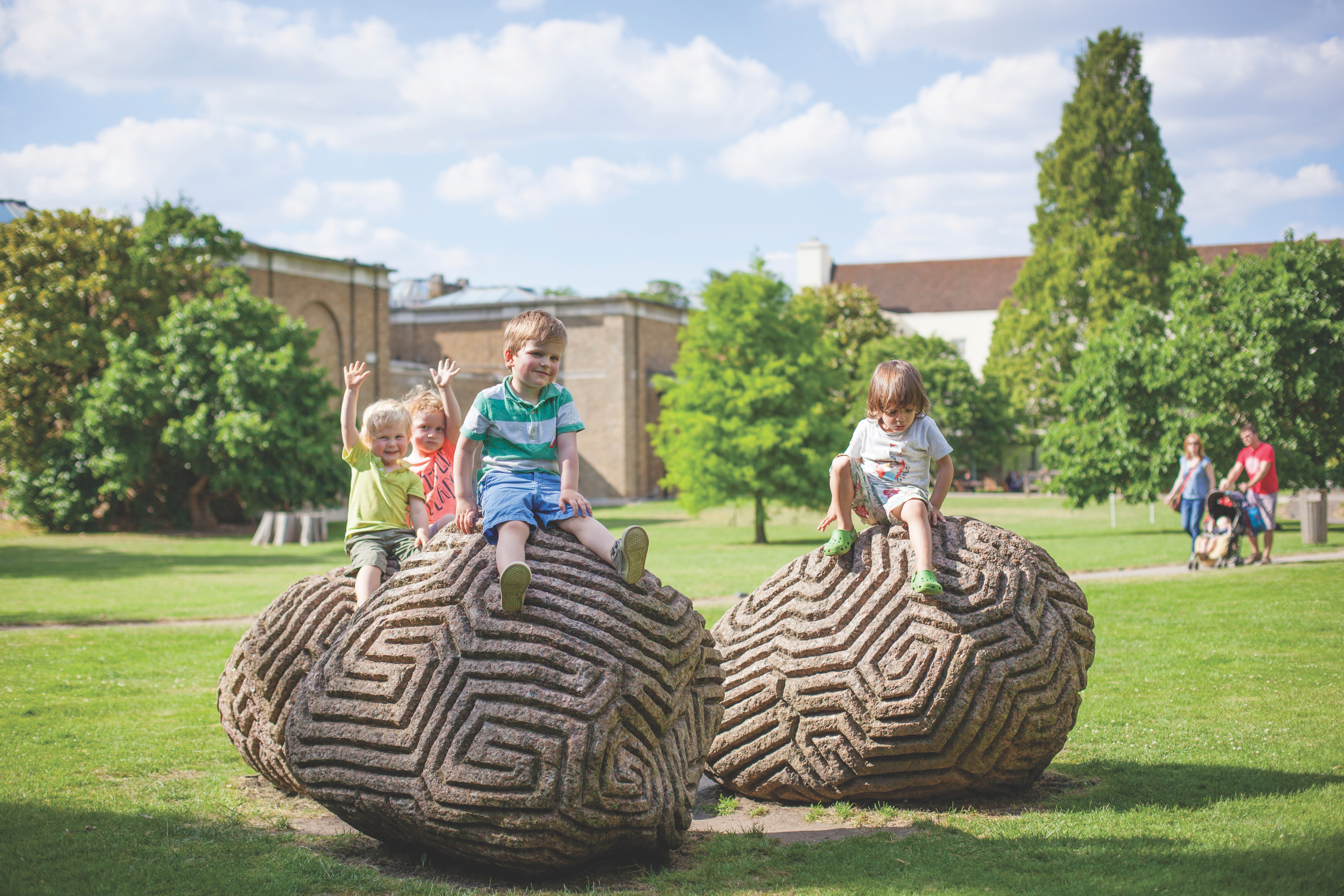 Children playing on Walking the Dog sculptures